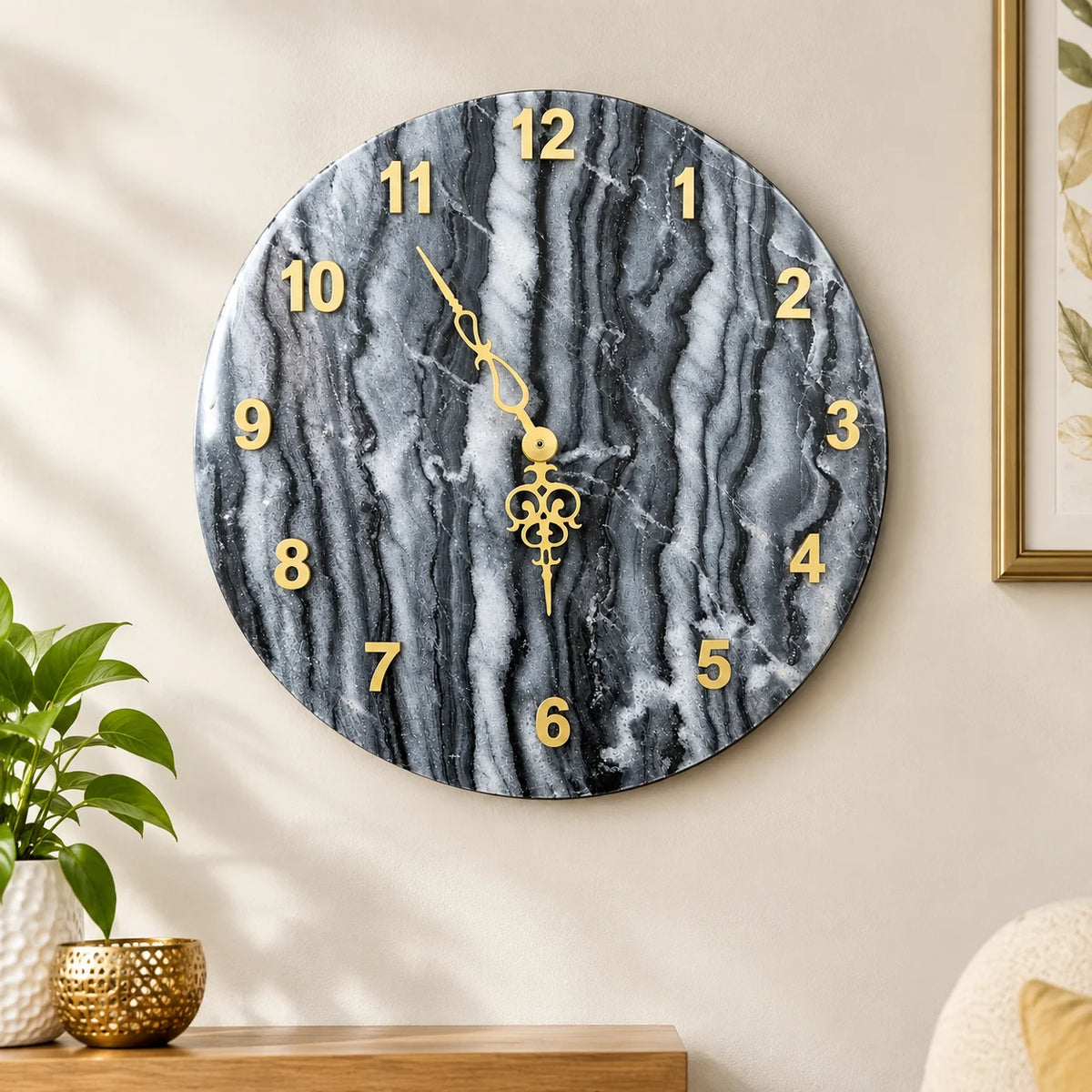 Premium black marble wall clock with contrasting golden hour numbers and ornate gold-tone hands, creating an elegant statement piece for contemporary interior design.