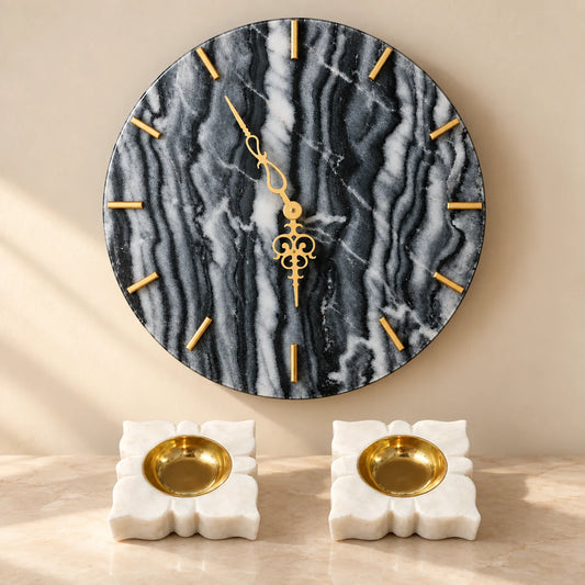 Black marble wall clock with two white marble diyas for home decor