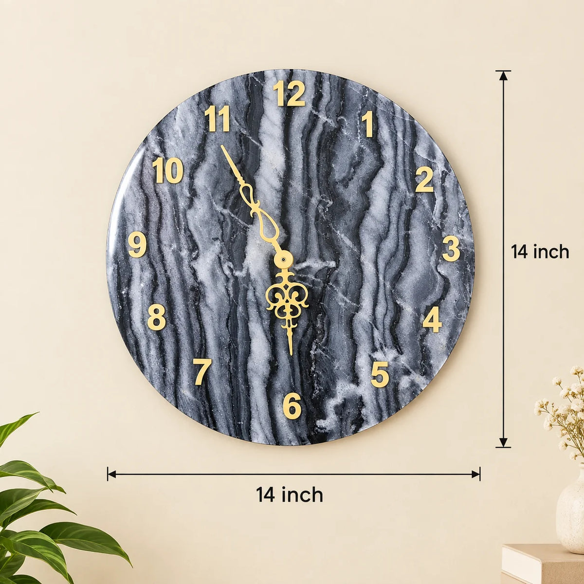 Round black marble wall clock with golden numerals displayed on a cream living room wall, complemented by elegant gold accents and modern luxury home décor.