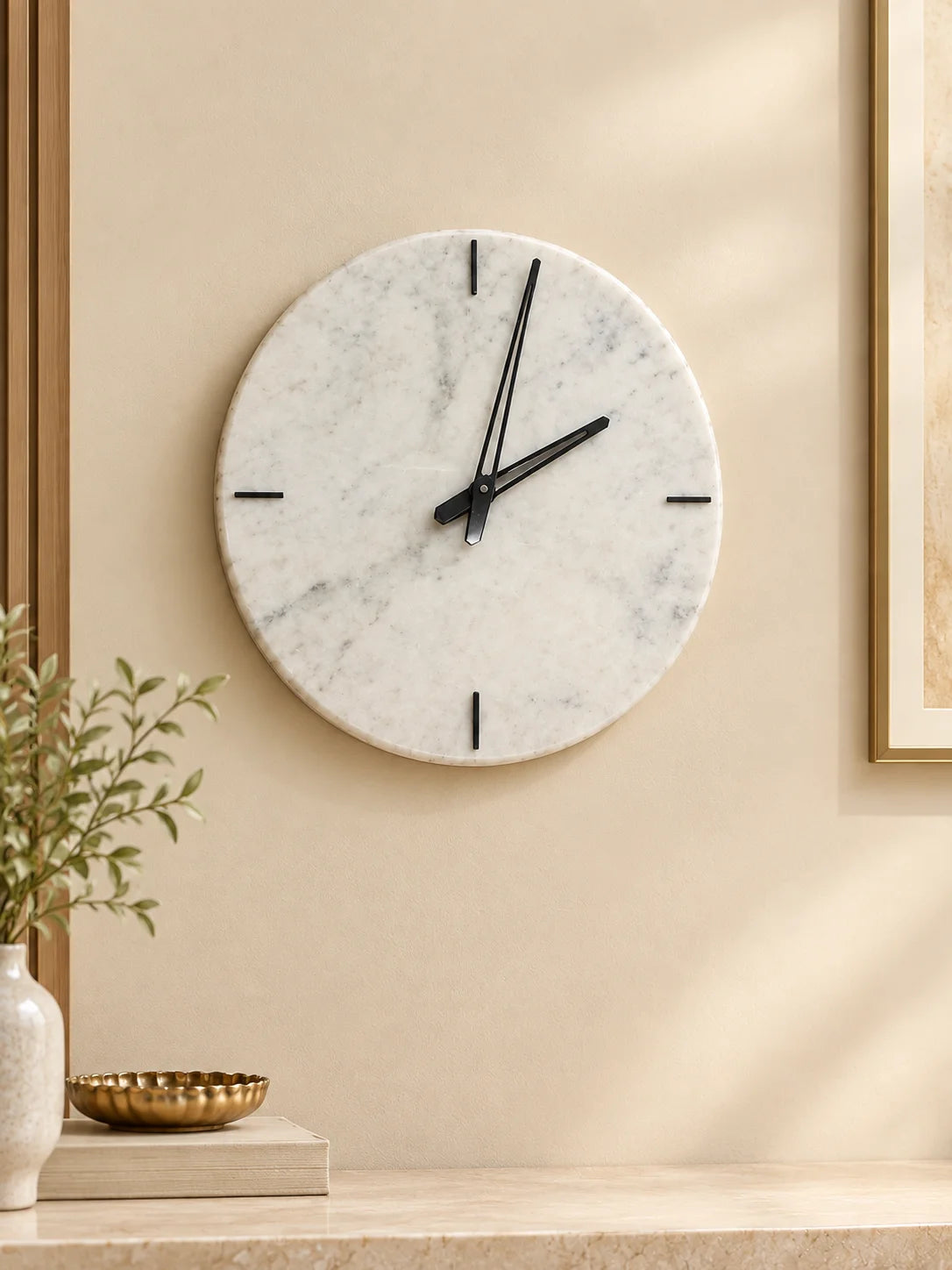 Marble wall clock displayed above a console table in an elegant home decor setting