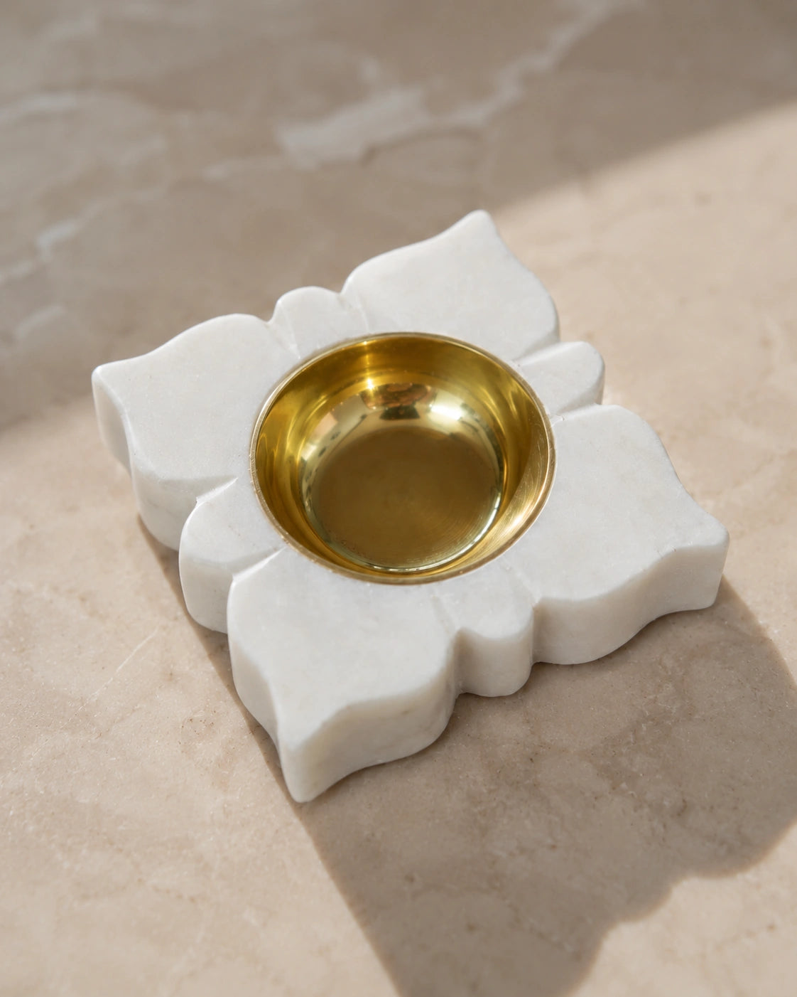 White marble diya with gold brass bowl on an elegant marble pooja surface, traditional Indian festive décor, Diwali home decoration and pooja room styling