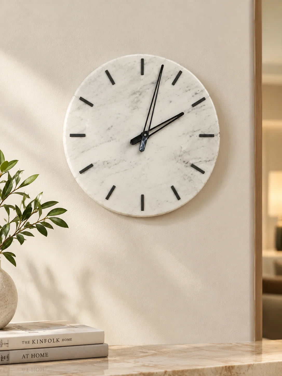 White marble wall clock with black hands for modern home decor