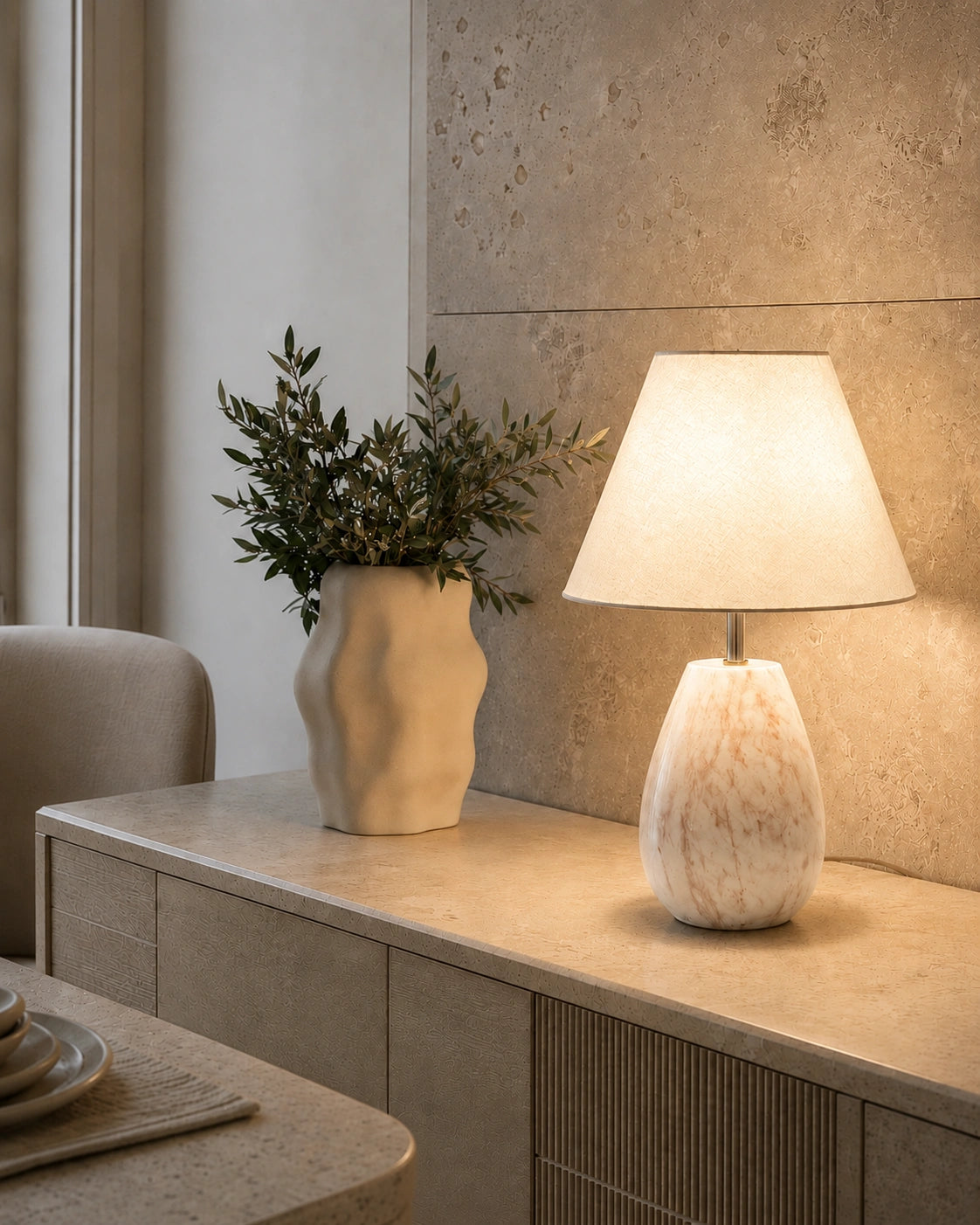 White stone-look decorative table lamp styled on a premium home décor sideboard
